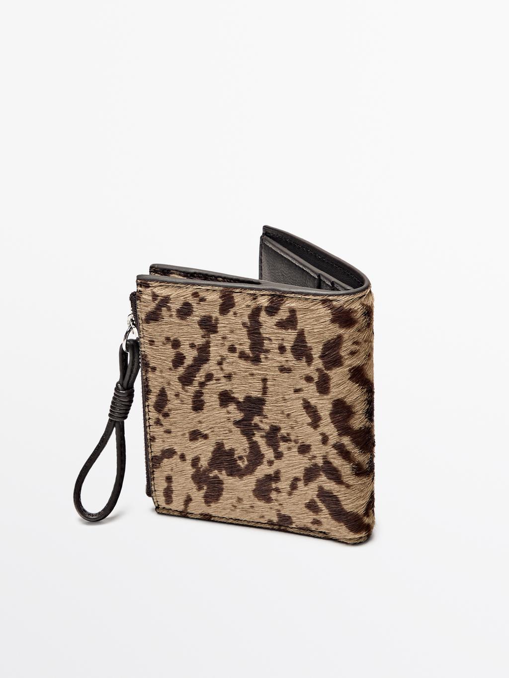 Animal print hair on leather wallet