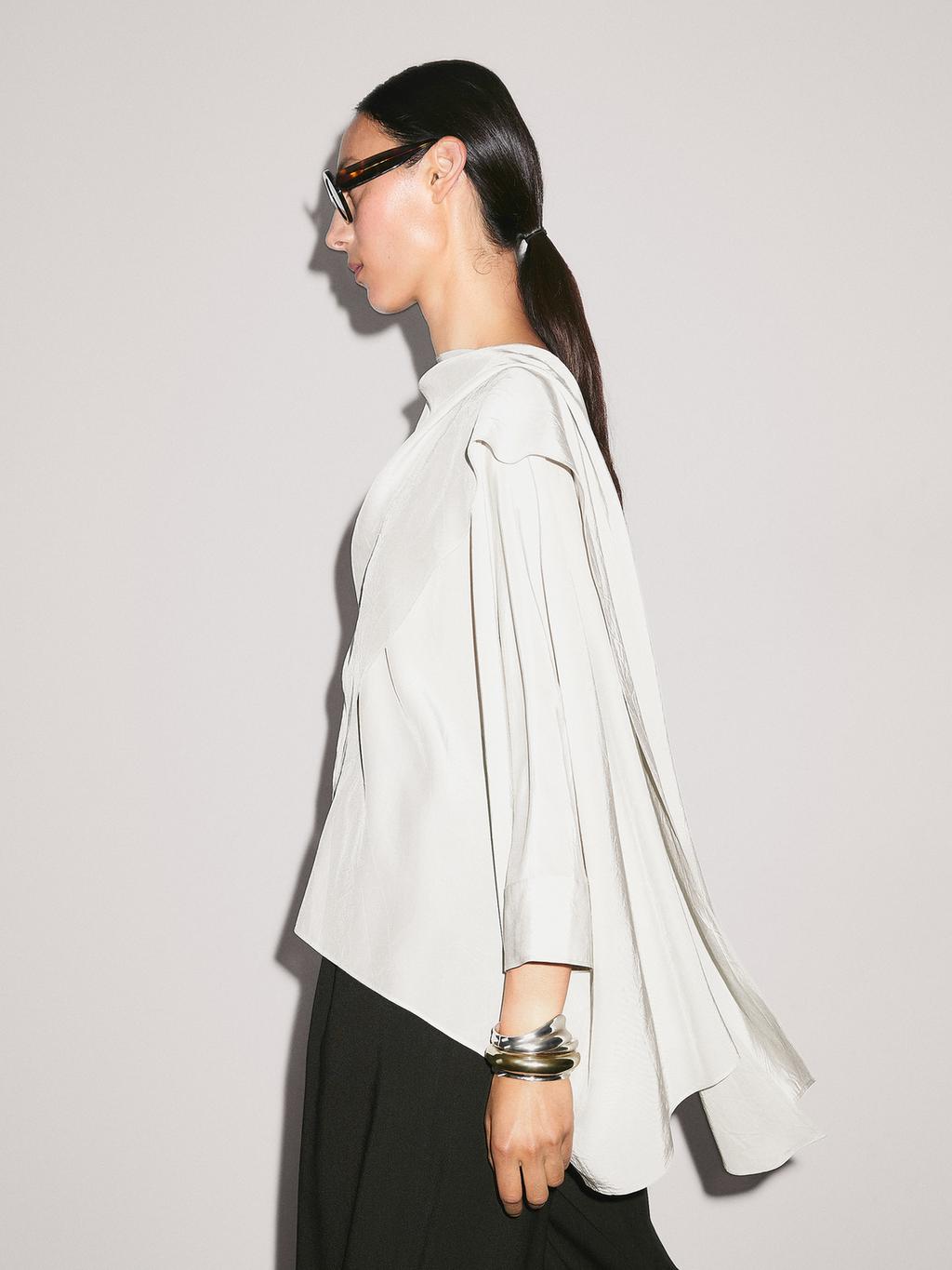 Short flowing cape with sleeve detail