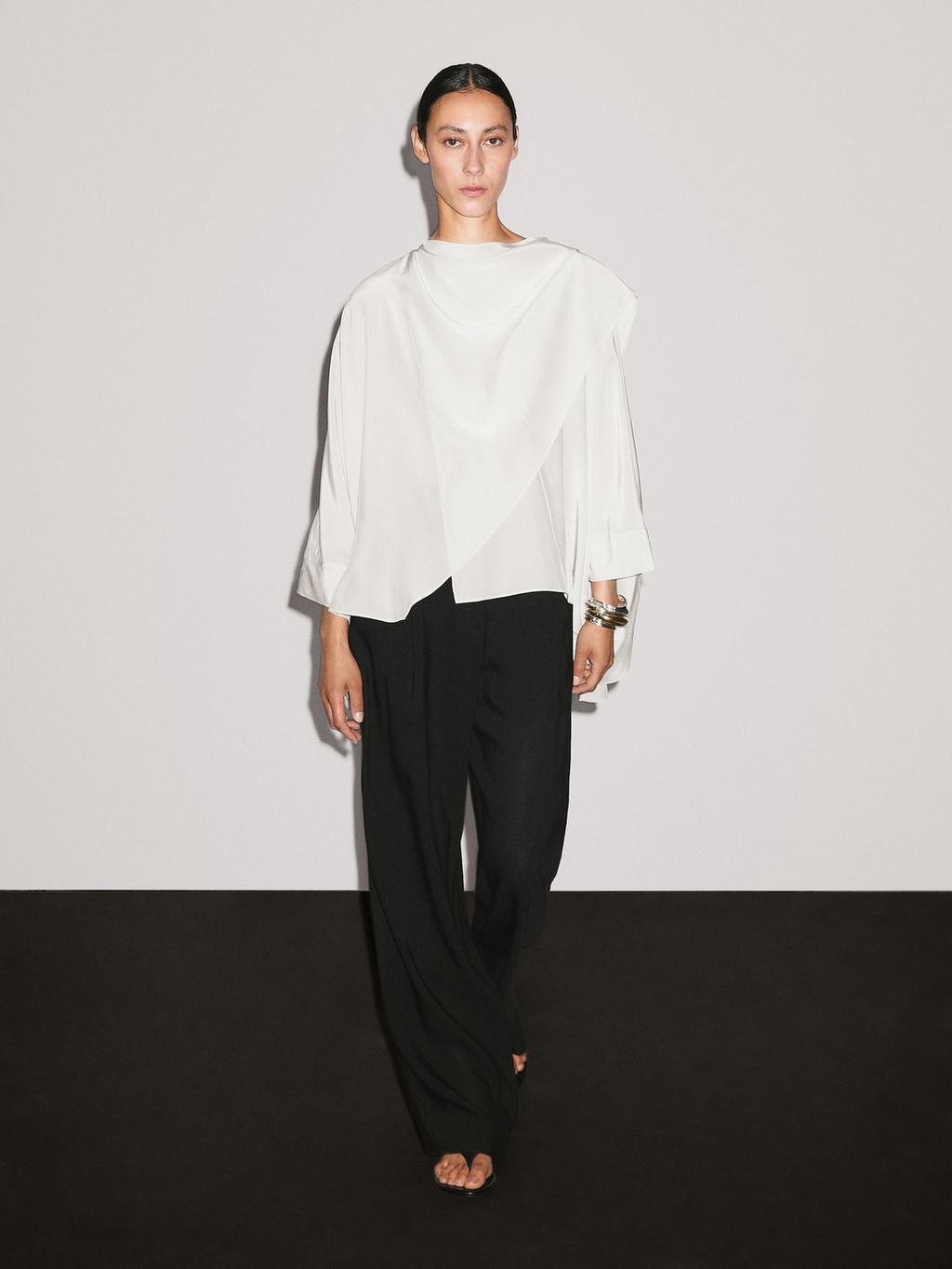 Short flowing cape with sleeve detail