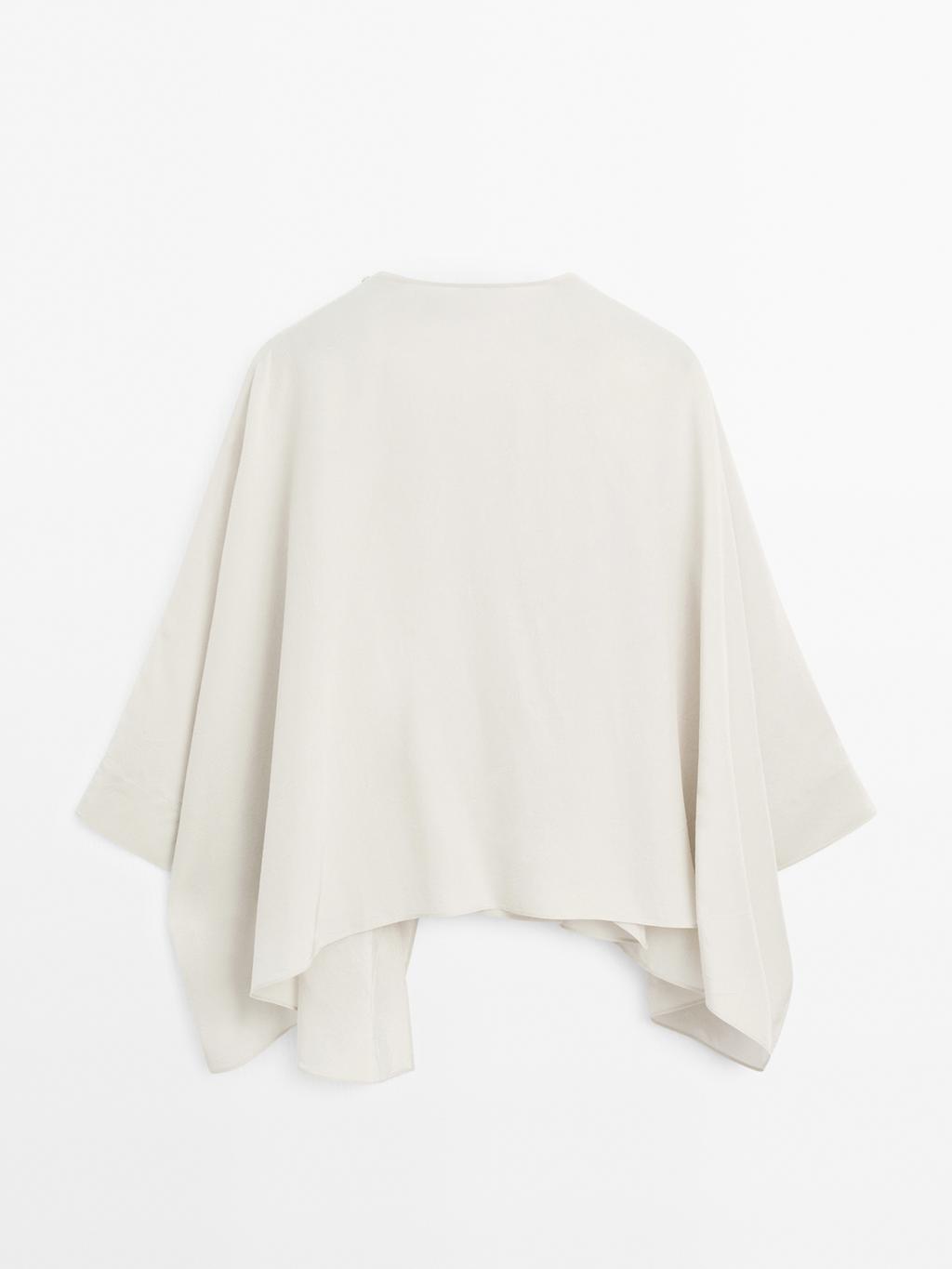 Short flowing cape with sleeve detail